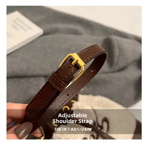 Detail of adjustable dark brown leather strap with gold buckle on luxury faux fur bag