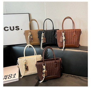 Detail view of woven bucket bags in five colors with quilted V pattern and cute charms