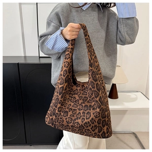 Macro shot of oversized leopard print tote bag in soft canvas texture for daily commute