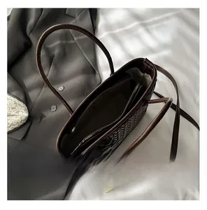 Top view of deep brown woven bucket bag with interior zip pocket and dual straps