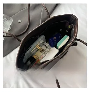 Deep brown tote bag showing large interior capacity for perfume and cosmetics