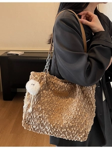 Brown fleece tote bag with leather strap and plush monster charm for winter
