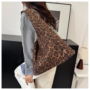 Detail view of the leopard print tote bag showing the side drape and spacious interior capacity