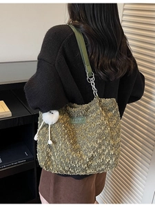 Green bouclé tote bag with leather strap, silver chain and white fluffy ball pendant