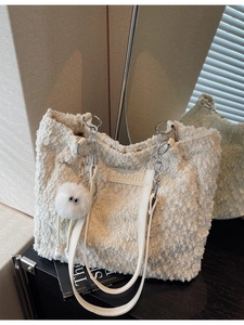 White faux fur tote bag with silver chain straps and cute monster plush pendant