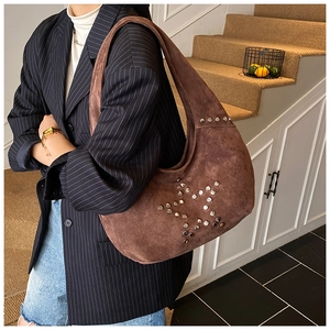 Detail of hobo shoulder bag in brown suede with silver star stud embellishments