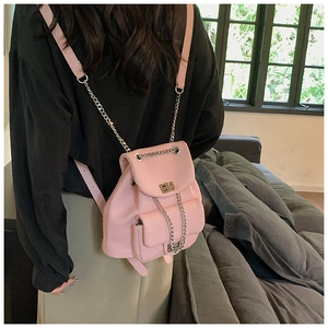 Detail of pink PU leather mini backpack with silver chain straps and metal twist lock