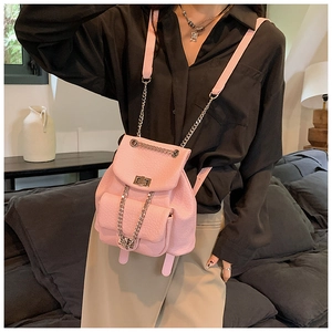 Detail of pink lychee textured leather backpack with silver chain strap and metal lock