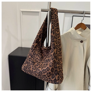 Macro shot of leopard print fabric texture and wide shoulder strap on tote bag