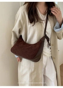 Detail of retro dark brown matte crossbody bag with unique knot on the shoulder strap