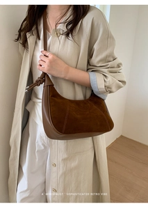 Detail of brown suede hobo bag with unique knot shoulder strap and crescent shape