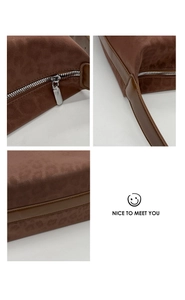Detail of leopard print tote featuring matte suede texture and brown leather shoulder strap