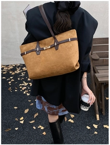 Detail of leopard print tote bag with gold buckle clasp and premium suede texture