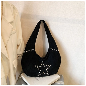 Close-up of black suede tote bag with silver star-shaped rivet details and rocker style