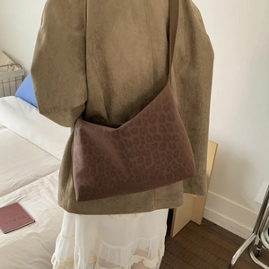 Detailed view of brown leopard print crossbody bag with soft suede texture and leather strap