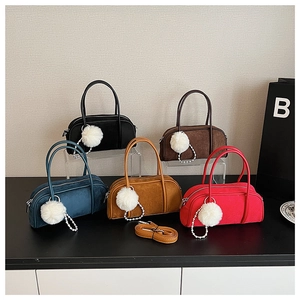 Detail of suede bowling bags in five colors with plush balls and pearl charms