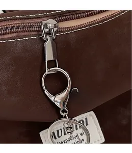 Detailed close-up of premium metal zipper and hardware on a vintage crossbody bag