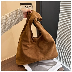 Close-up of brown suede leopard tote bag showing soft slouchy structure and large capacity