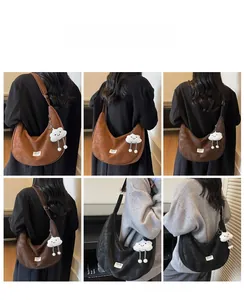 Detail of large hobo bag with adjustable strap and plush cloud charm in 3 colors