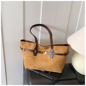 Detailed close-up of brown leopard tote bag featuring premium suede texture and leather buckles