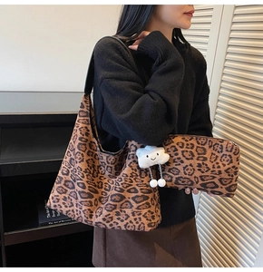 Detail of leopard print tote and pouch set with white plush cloud charm accessory