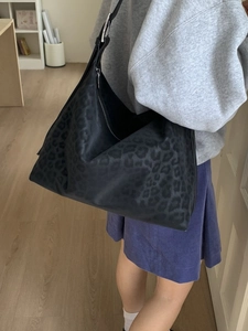 Large black leopard print hobo bag in matte finish with adjustable shoulder strap