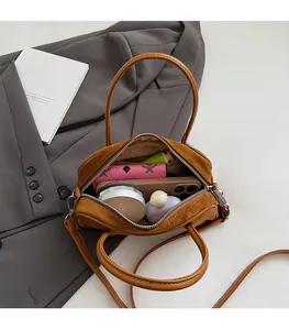 Detail view of brown suede bowling bag interior showing large capacity for essentials