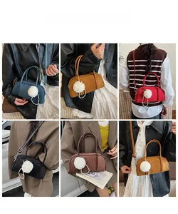 Detail showing mini Boston bags in five colors with decorative fur ball and pearl chain