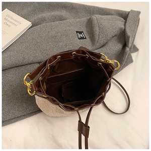 Close-up of winter plush bucket bag showing sheepskin texture and leather drawstring interior