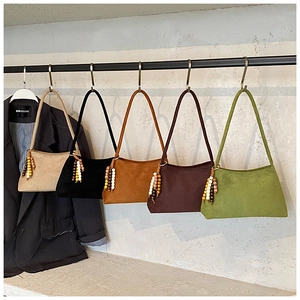 Five assorted retro underarm bags in matte finish with colorful wooden bead ornaments