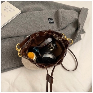 Top view of plush bucket bag showing spacious interior with cosmetics and drawstring closure