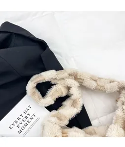 Detail of soft beige plush shoulder strap and metal zipper on cozy winter crossbody bag
