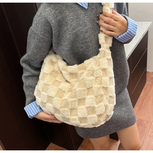 Close-up of off-white plush checkerboard shoulder bag for autumn winter fashion