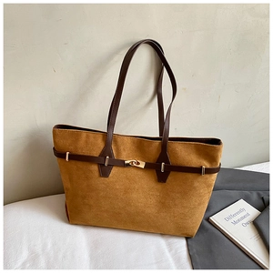 Close-up of the ginger leopard suede tote bag featuring brown leather straps and metal buckle