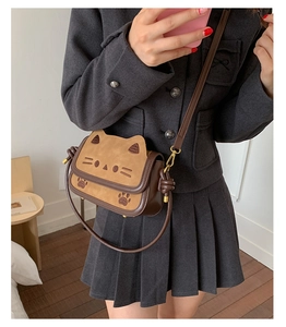 Detailed view of cute cat shaped crossbody bag with embroidered whiskers and 3D ears