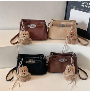 Close-up of matte textured shoulder bags in four colors with cute plush bear charms
