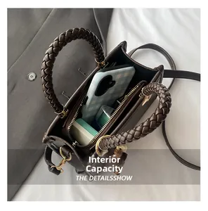 Internal capacity of the vintage brown handbag with woven handle and gold hardware detail