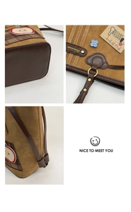 Close-up of brown suede bag with puppy embroidery, floral accents and leather trim