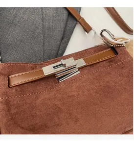 Detail of vintage brown suede Kelly style bag with polished silver turn-lock closure