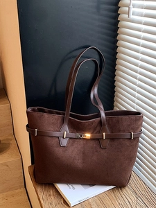 Brown suede tote bag with leather strap and gold buckle in a minimalist vintage style