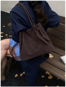 Detail of dark brown matte tote bag with matching small pouch in retro autumn setting