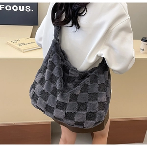 Detail view of the soft grey checkerboard plush texture on a large slouchy tote bag
