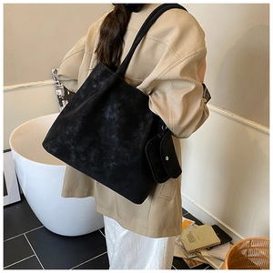 Detail of black vintage matte tote bag showing stone texture and matching pouch