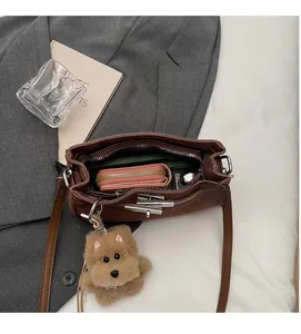 Interior view showing the large storage capacity of the brown faux leather Kelly bag