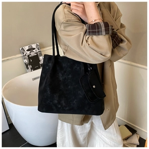 Detail of black suede tote bag with detachable mini pouch for daily commute styling
