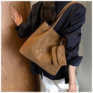 Close-up of caramel brown matte tote bag with matching inner pouch for daily commute