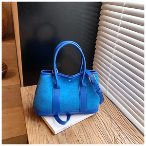 Dettaglio di una borsa tote blu patchwork in pelle scamosciata opaca e morbida pelle sintetica