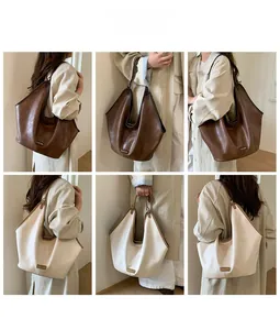 Close-up of stylish large tote bag details with leather texture and metal logo plate