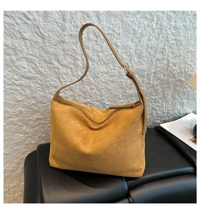 Detail of ginger suede hobo bag featuring soft texture and adjustable leather strap