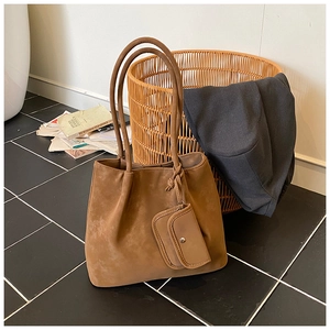 Detailed view of the brown suede tote bag with matching inner pouch and slim straps